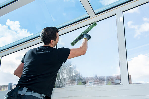 professional cleaning window inside commercial building